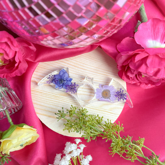 Resin page holder featuring real preserved flowers, handmade in Utah.